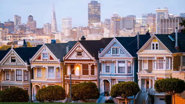 The iconic painted ladies houses with San Francisco downtown skyline in the distance.