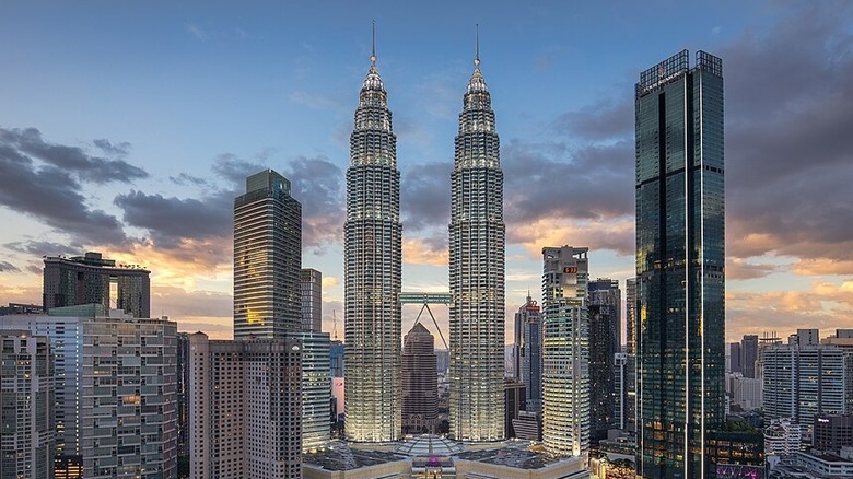 The Twins in Kuala Lumpur as part of city skyline at sundown
