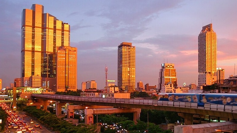 Bangkok, Thailand city and train at sunset