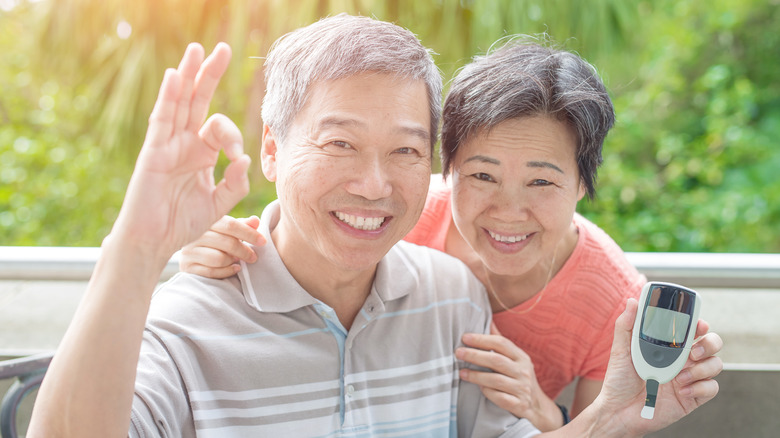 An elderly couple smiling