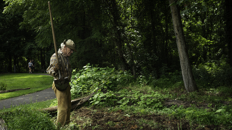 An elderly man with a shovel