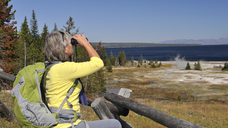 An elderly woman with binoculars