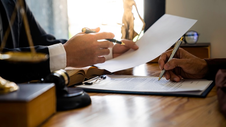 a lawyer filling out paperwork