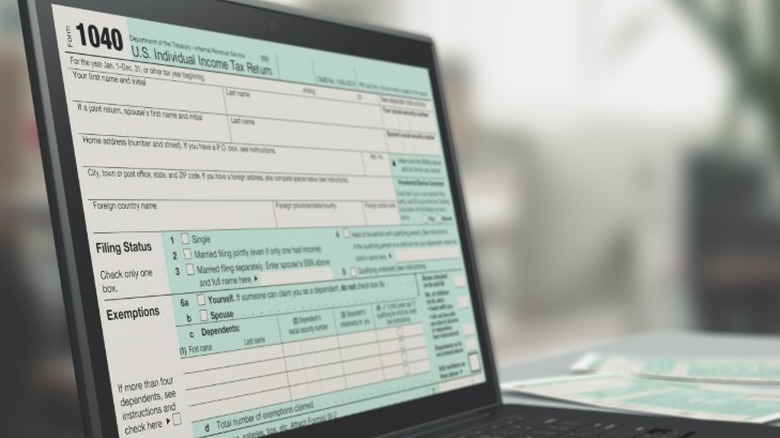 A 1040 tax return form open on a laptop screen.