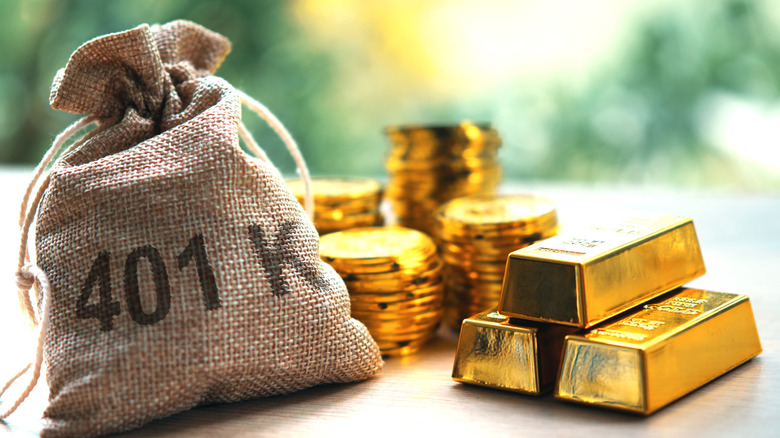 401(k) on a bag of money next to gold bars