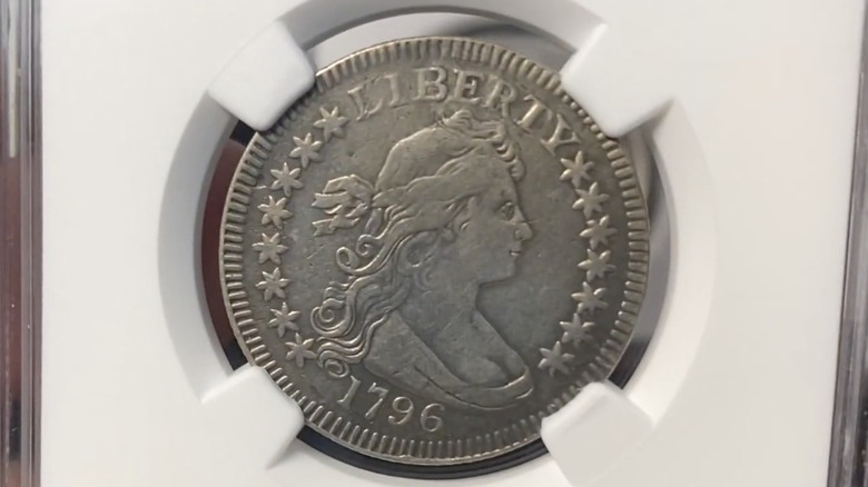 The front of a 1796 Draped Bust quarter in protective casing