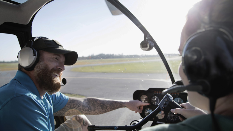 helicopter pilot instructing student.