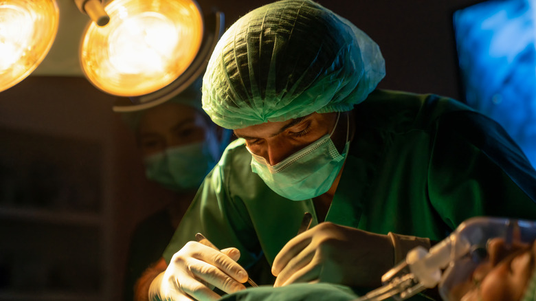 Plastic surgeon in operating room.