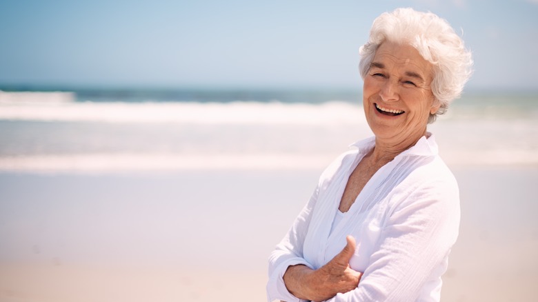 Older woman with white hair on Florida beach smiling