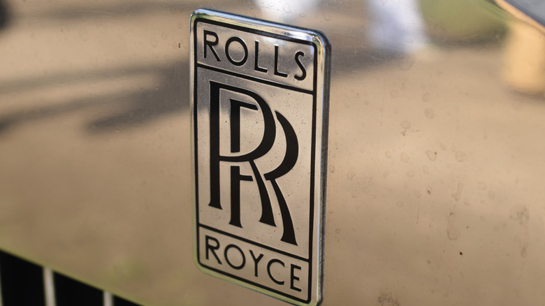 Close up shot of the black Rolls-Royce logo of a classic Rolls-Royce