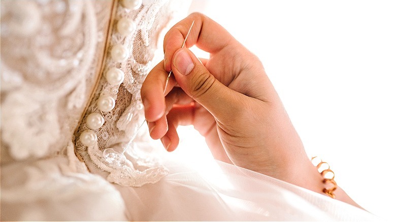 Seamstress customizing wedding dress