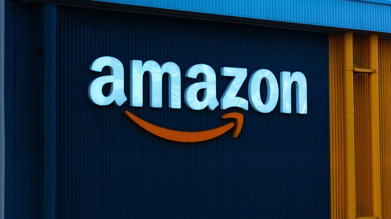 Close up view of an Amazon sign and corporate Amazon logo on an Amazon warehouse