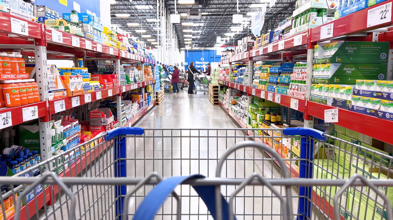 A shopping cart driving down store aisle
