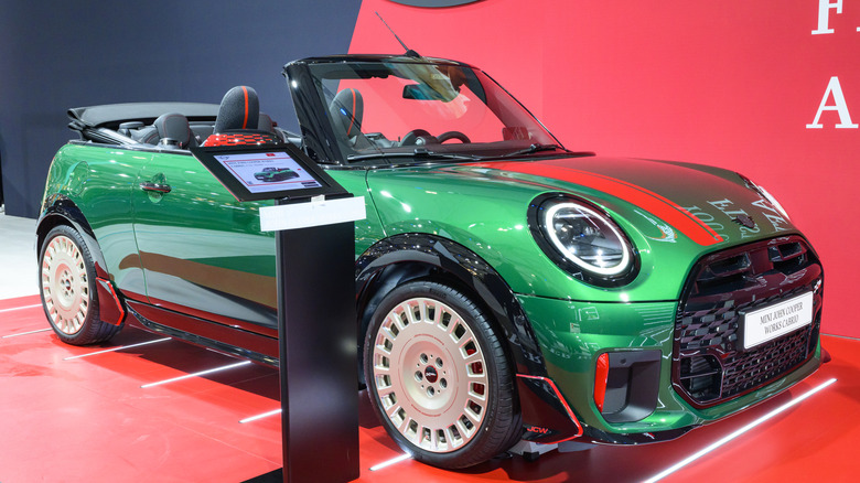 A green and red Mini John Cooper Works signature convertible on display