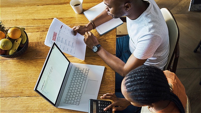 Two people calculating finances