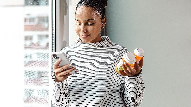 Person holding their prescriptions
