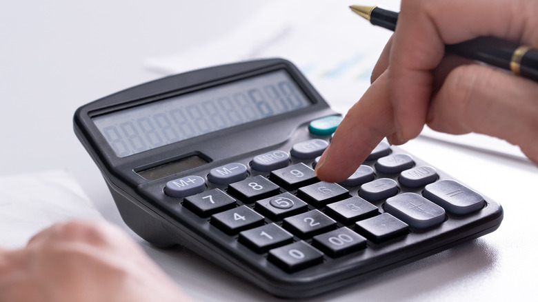 Person using calculator in office