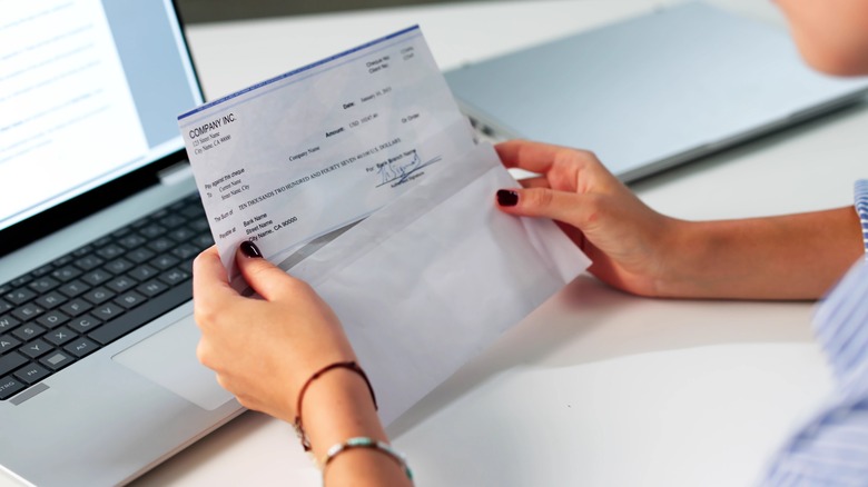 Woman looking at paycheck
