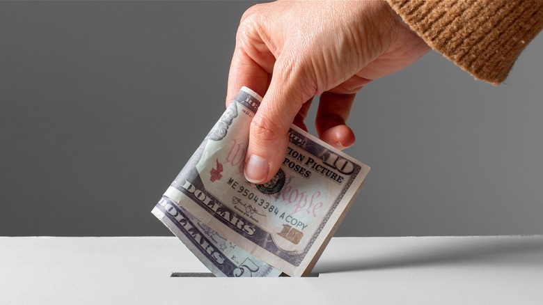 Person giving cash donation