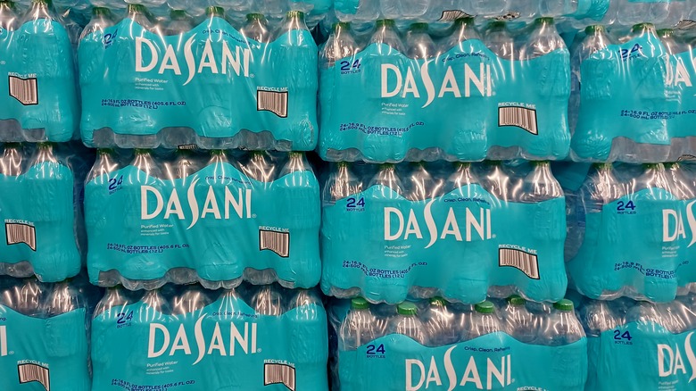 stacks of 24-packs of Dasani water bottles