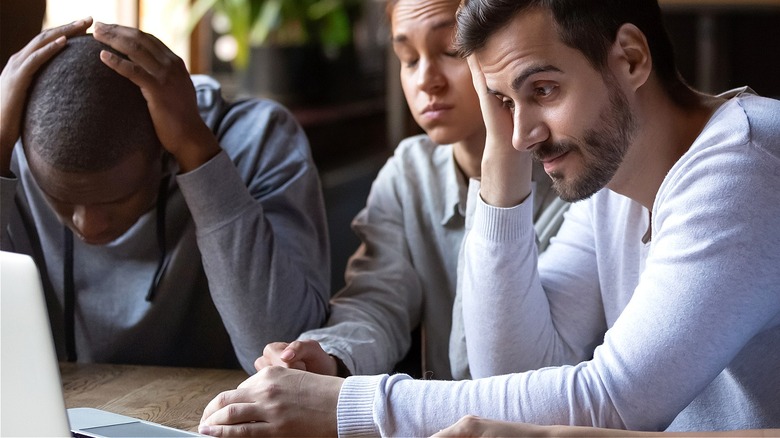 People on smartphones looking disappointed