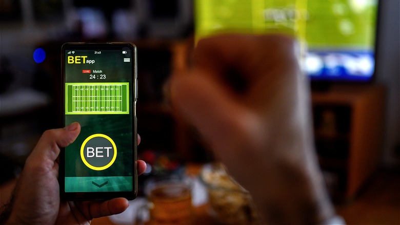 Person fist-pumping air after bet