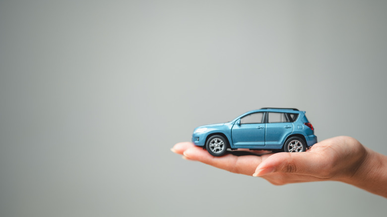 Hand holding a small model car