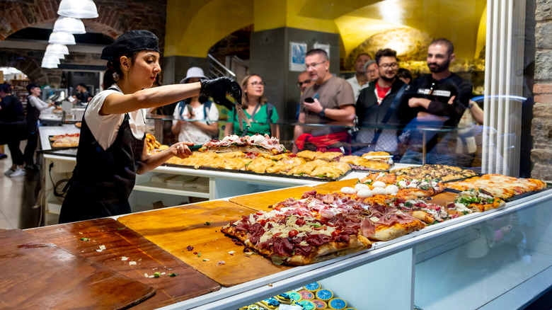 Customers standing in line at casual eatery in Italy