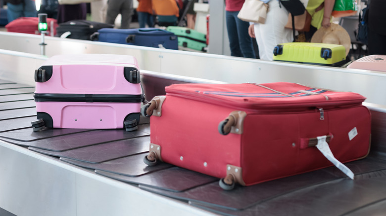 Two suitcases on a baggage conveyor built in airport