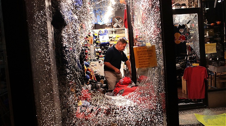 Broken window, shopkeeper inside store