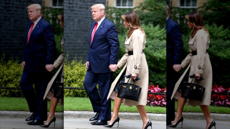 Melania Trump holding a Birkin bag while walking with Donald Trump