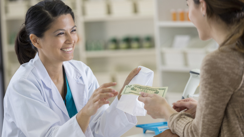 Woman paying with cash