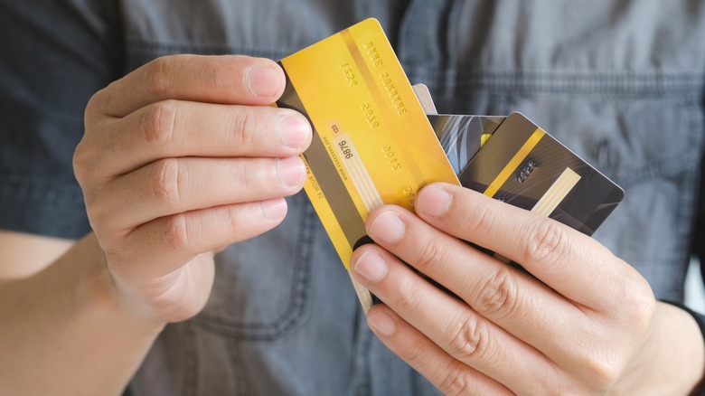 man holding credit cards