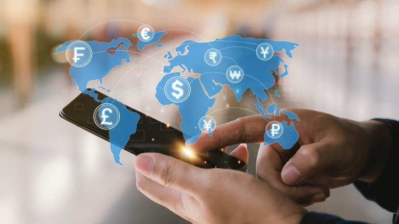 Phone, currencies, and world map