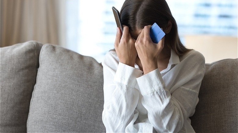Financially distressed person holding phone