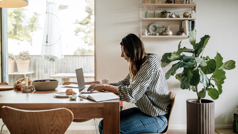 Woman working from home at a kitchen table
