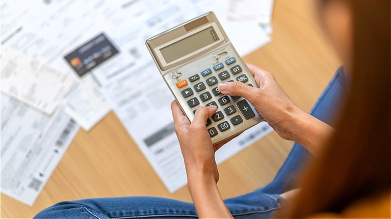 Person calculating credit card statements