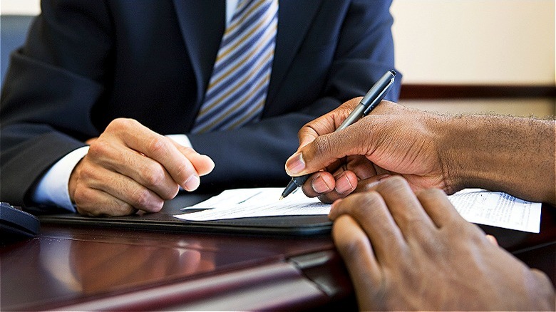 Person signing a contract