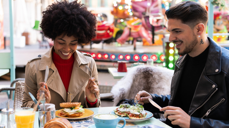 Friends enjoying a meal in an outdoor terrace of a brunch