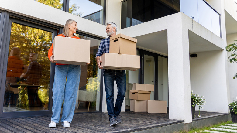 senior couple moving boxes from house