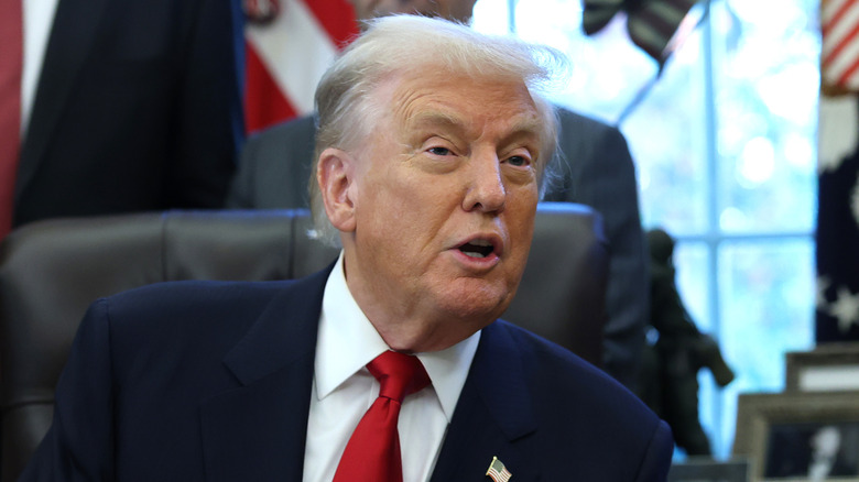 President Donald Trump sitting in a chair and speaking