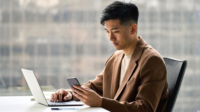 Person reading phone by window