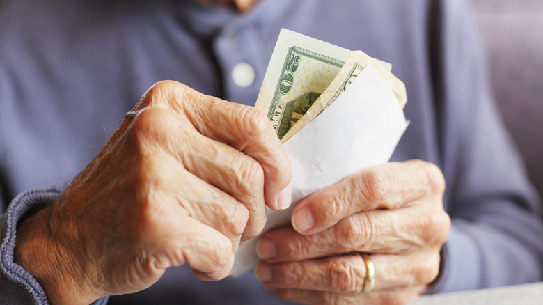Senior man holding cash in his hands