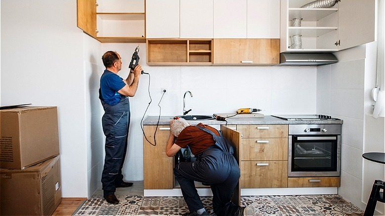 People remodeling kitchen