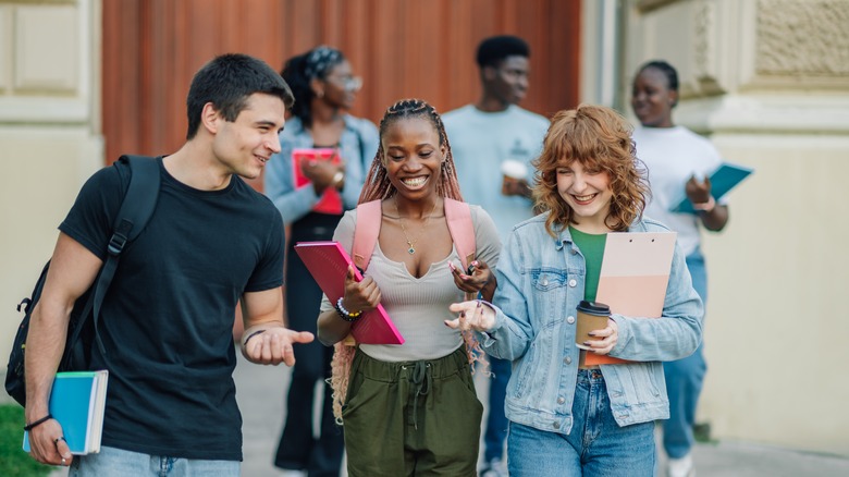 College students walking with their course materials