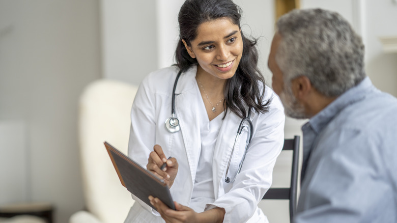 Young woman explaining options to a senior