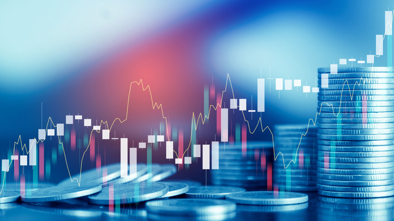 coins stacked up with stock chart overlaid on image