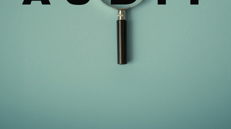 audit and a magnifying glass