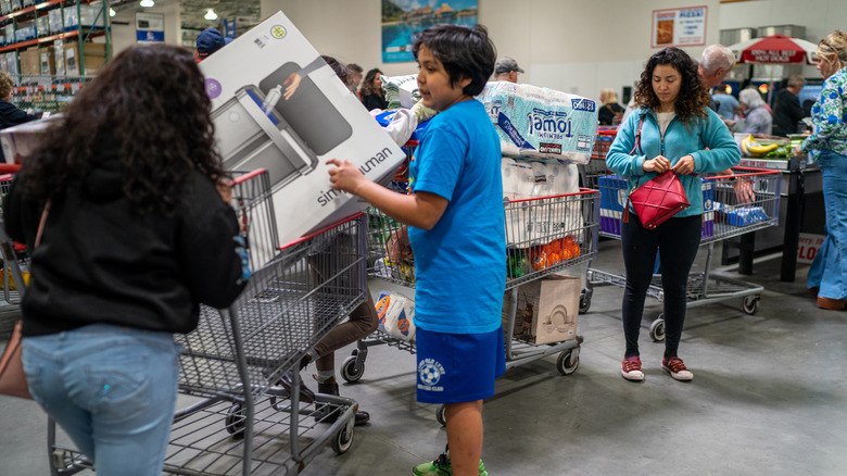 ustomers line up at the check out booth on April 18, 2025 at a Costco branch in Niantic, Connecticut.