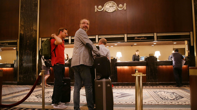 People check-in to New York's landmark Waldorf Astoria Hotel